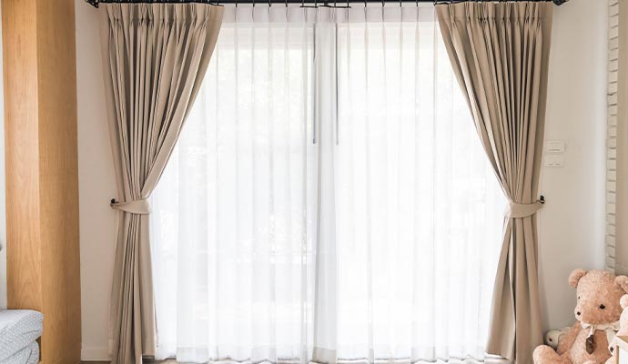 Clean draperies hanging on the window of a living room